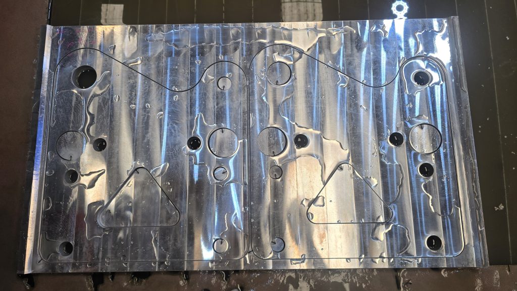 A batch of cut brackets and plates from one nest